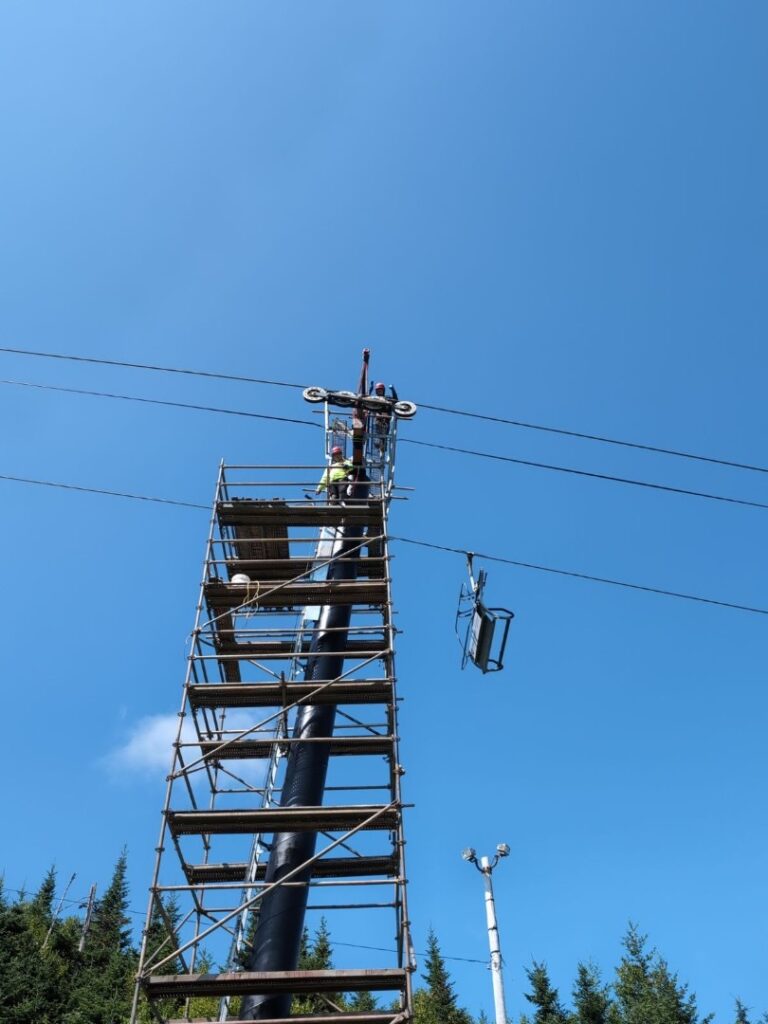 Ski lift getting treated for rust for the season.